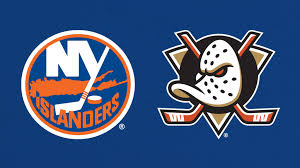 The image shows the New York Islanders logo on the left and the Anaheim Ducks logo on the right, both set against a blue background.
